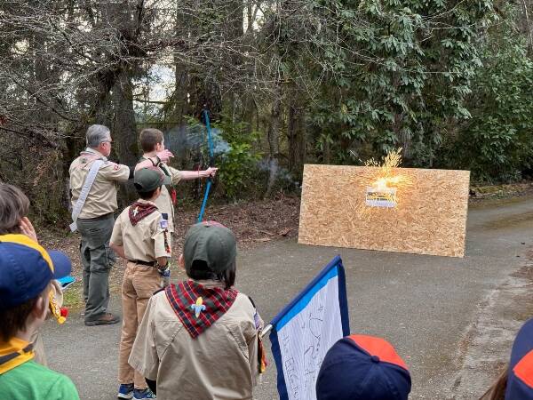 A Cub Scout shoots an “Arrow of Light” at the Crossover Ceremony, signifying the transition to Scouts BSA Troop 294 (Courtesy Photo).