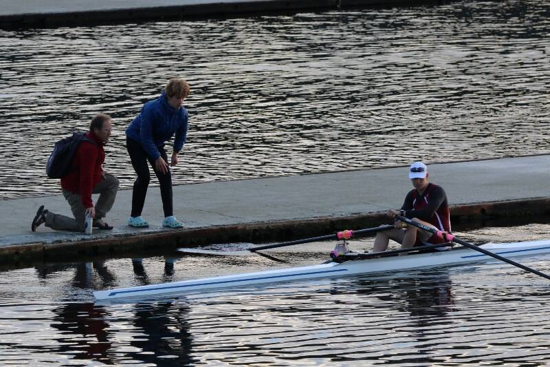 BBRC Coach Richard Parr and eighth-grader Briar Guenther stood on the dock, while Grant Gonter launched his U17 Single at Brentwood (Laird Gonter Photo).