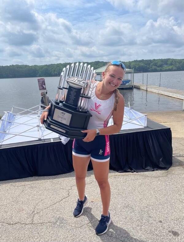 Former Burton Beach Rower, Kate Davis, holds the trophy as the University of Virginia team celebrates their ACC championship (Becca Davis Photo).