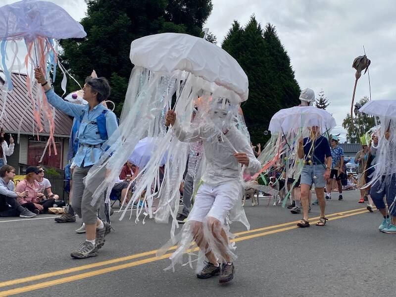Shimmery and colorful costumes abounded in Vashon Island Marine Band and Procession, in last year’s Strawberry Festival parade (Tom Hughes Photo).