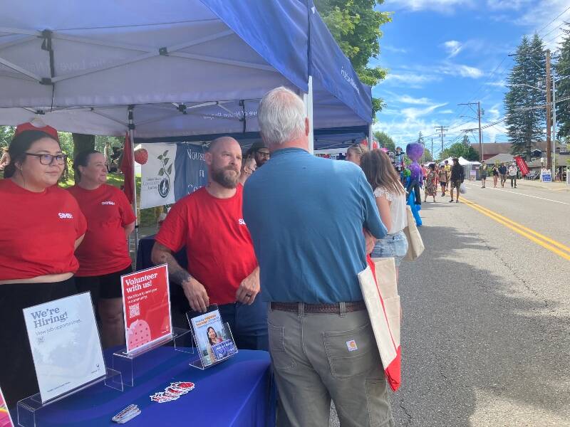 At Vashon’s Strawberry Festival, staff members of the Seattle Indian Health Board, including islander Brian Springfield, answered questions from islanders who stopped by the organization’s booth (Elizabeth Shepherd Photo).