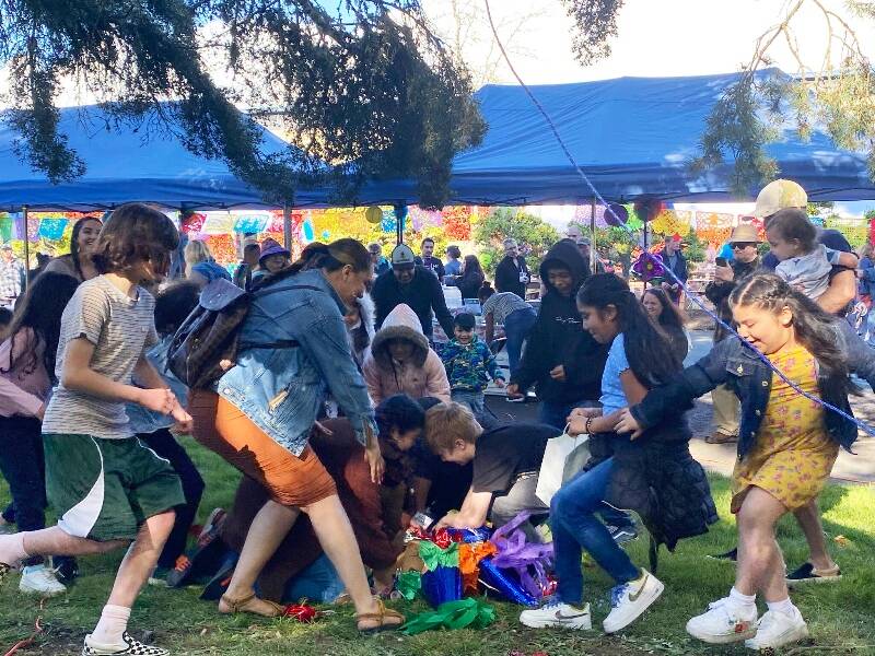 At the Mercado hosted last year by Comunidad, kids rushed to claim candy that spilled from a huge piñata (Tom Hughes).
