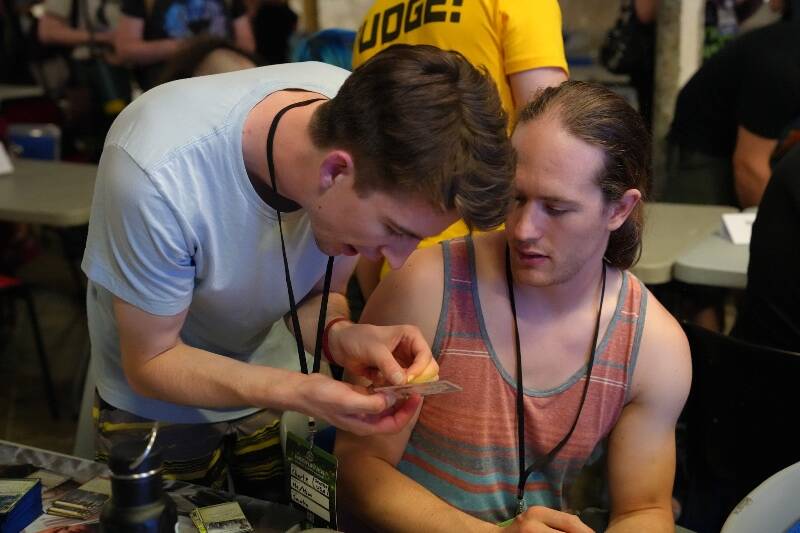 Charlie (left) and Abraham McBride run an alternate format of Netrunner they designed called “Chimera” at the World Championships (Saif Choudhury Photo).