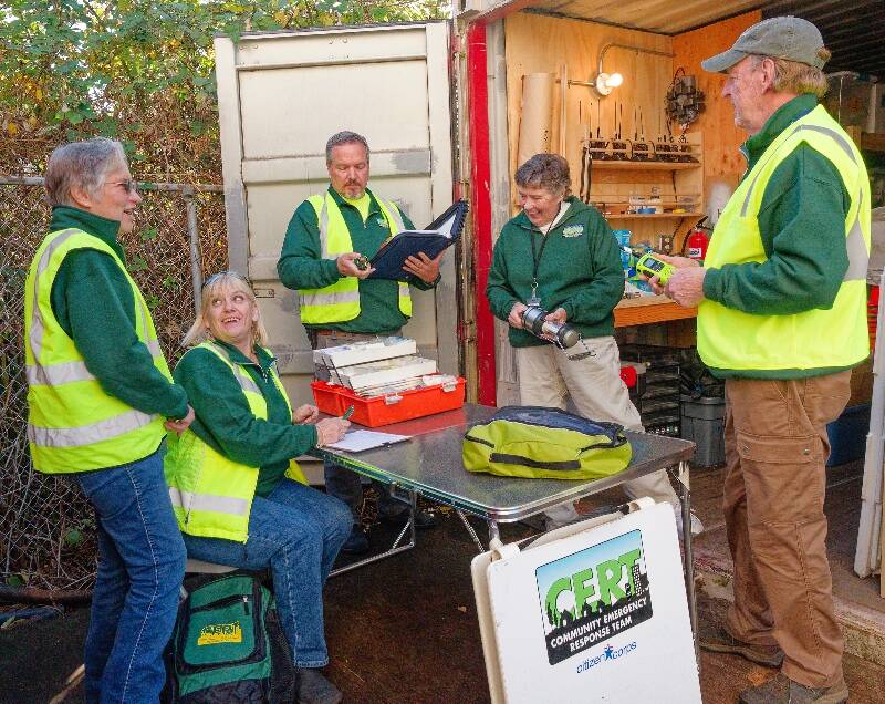 Vashon CERT team leaders work on a project to make sure the unit’s cache of equipment and supplies is in great shape as the winter storm season approaches. From left to right: Marie Bradley, Jan Lyell, MJ Witt, CERT Manager Jan Milligan, and Allen de Steiguer (Rick Wallace Photo).