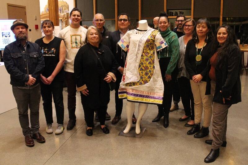 Members of the Seattle Indian Health Board team, at an event at Vashon Center for the Arts that featured (center, behind artwork) Health Board Executive Vice President and artist Abigail Echo-Hawk (Pawnee). (Alex Bruell Photo)