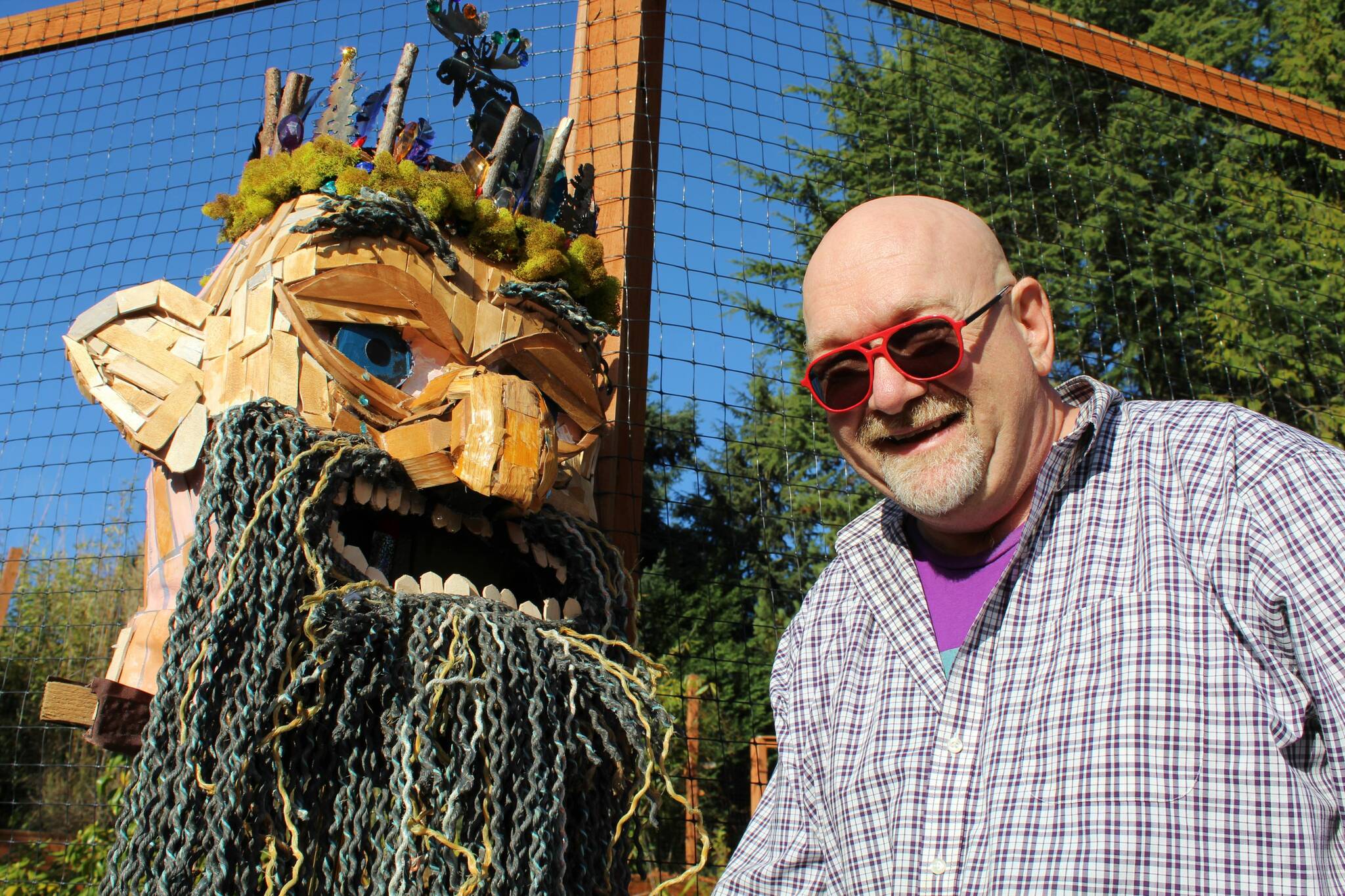 Matt Beursken smiles next to the headpiece of Edgar the Forest King, his Thomas Dambo-inspired troll costume. Alex Bruell photo