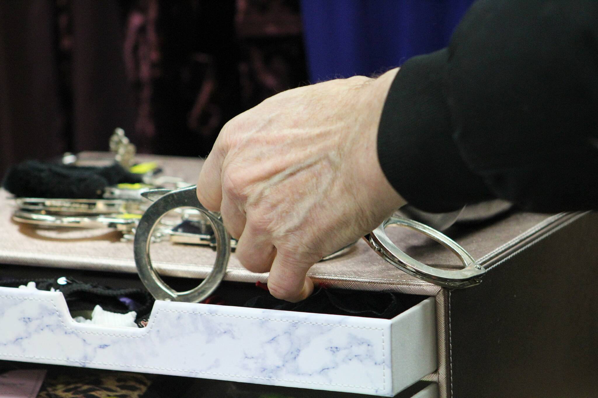 A shopper peruses a pair of handcuffs. Alex Bruell photo
