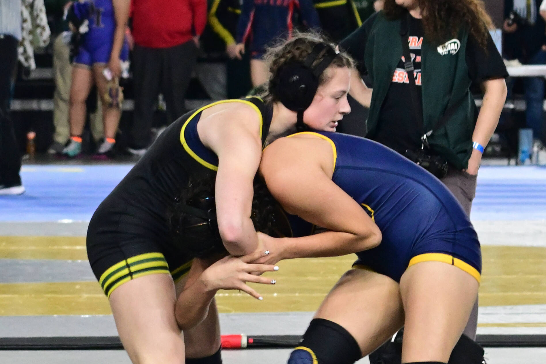Stephen Murphy photo Lena Puz (left) fights for her quarterfinals victory over freshman Abbygale Garza from Wapato.