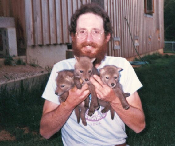 Courtesy photo
Brooks Fahy in Oregon,1987, holds three coyote pups orphaned by a government trapper. They were ultimately released successfully into the wild.