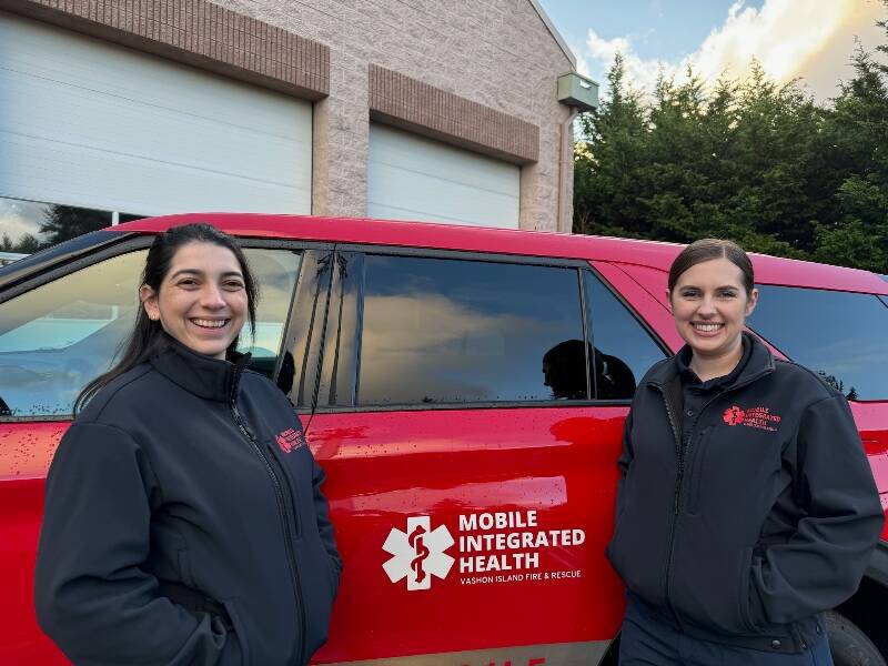 Mobile Integrated Health manager Lilie Corroon (left) and registered nurse Ashley Soares stand in front of the program’s vehicle (Vashon Island Fire Rescue Photo).