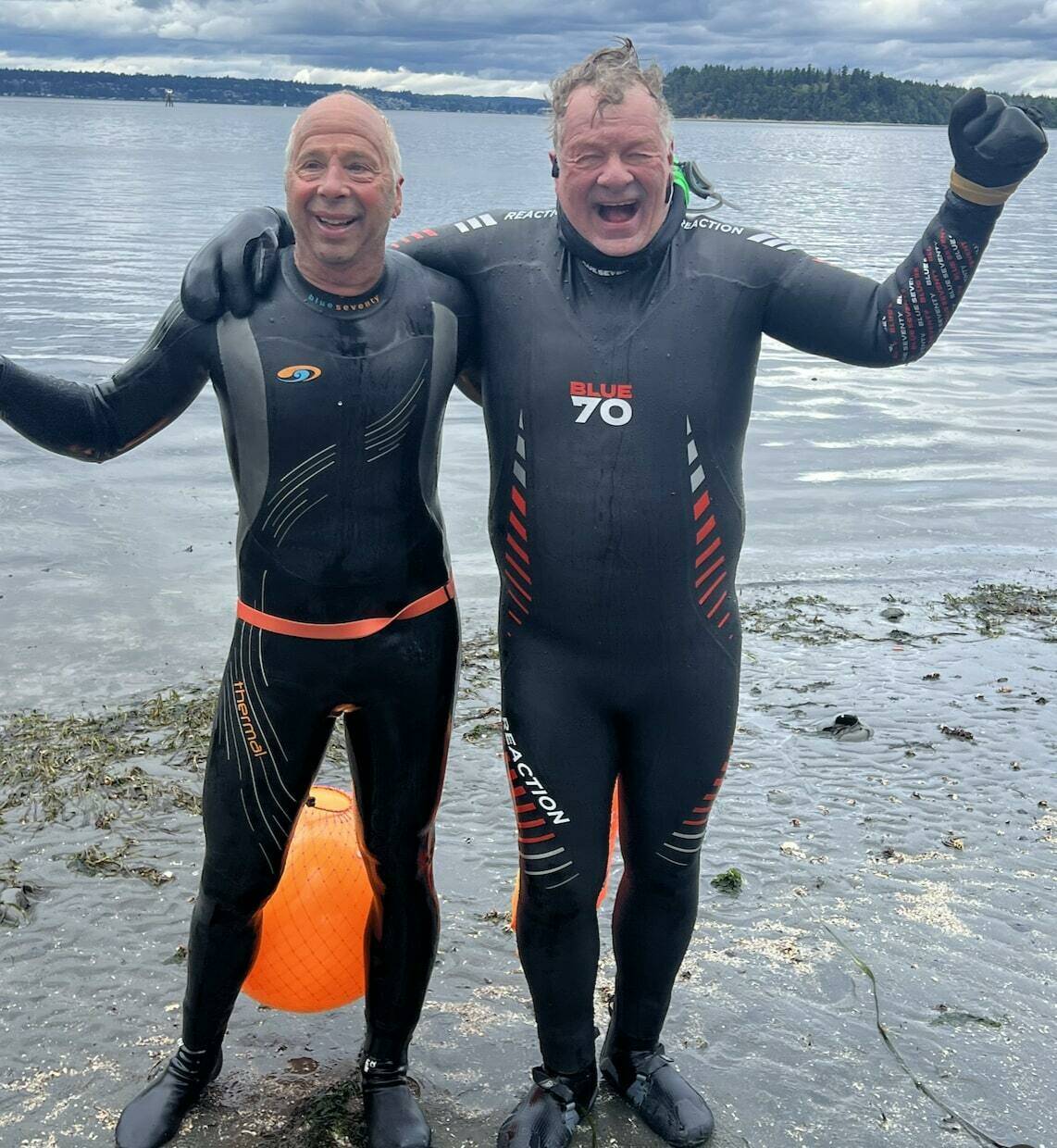 Joe Yarkin (left) and Theo Eicher celebrate the conclusion of their dock to dock swim at the north end ferry dock. (Pat Call photo)
