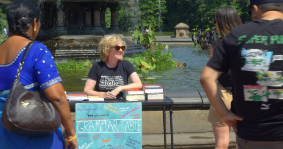 Brant Johnson Photo
Ellen Jovin welcomes visitors to her roving Grammar Table in “Rebel With a Clause.”
