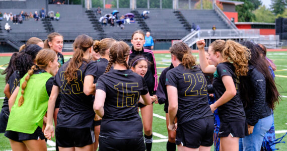 Dawn Stief Photo
Junior and co-captain Lillith Provo leads the huddle before kickoff.