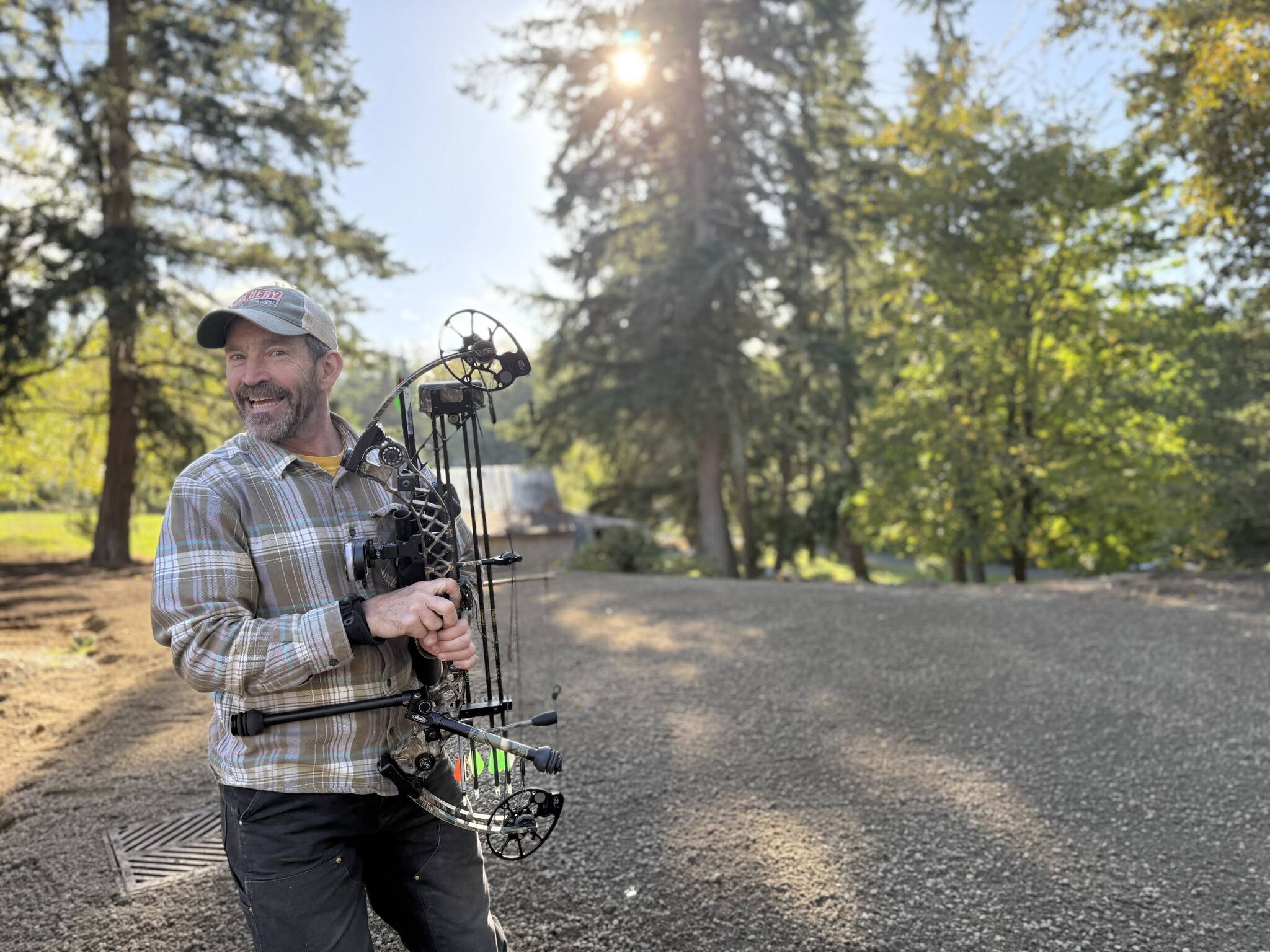 James Cottrell holds the bow he uses for deer hunting on Vashon, where he teaches others how to hunt safely and humanely. (Aspen Anderson Photo)