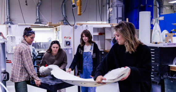 Rocketkar Studios Photo
Vashon Nature Center education director Maria Metler (left) works with whale ambassador volunteers to prepare a mandible, or lower jawbone, for a protective resin coating.