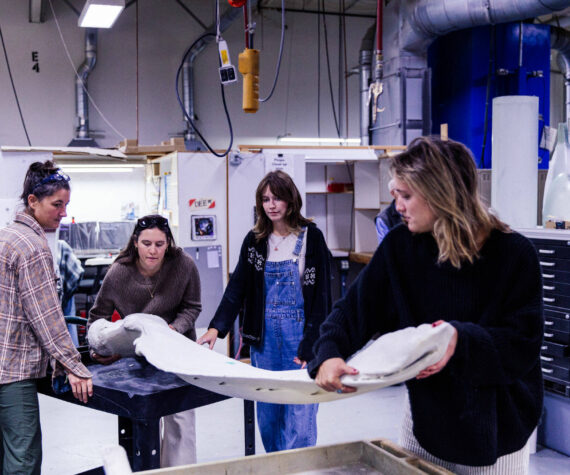 Rocketkar Studios Photo
Vashon Nature Center education director Maria Metler (left) works with whale ambassador volunteers to prepare a mandible, or lower jawbone, for a protective resin coating.