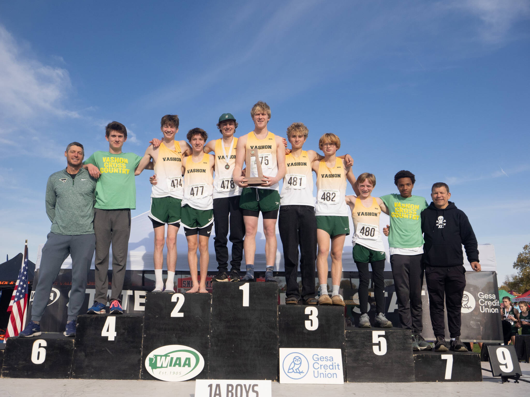 The Vashon boys cross-country team celebrates its fourth-place podium finish at the state championships in Pasco on Nov. 8. (John Decker Photo)