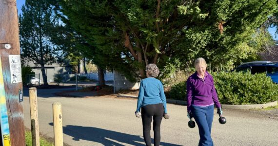 Vashon Strong legends step outside for their farmers carry, soaking up a stretch of rare November sunshine. Vashon Strong is tucked in the alley behind Giraffe at 17630 Vashon Hwy SW. (Aspen Anderson Photo)