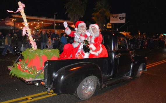 Mr. and Mrs. Claus wave to their fans as the parade rolls through town. (Jim Diers Photo)
