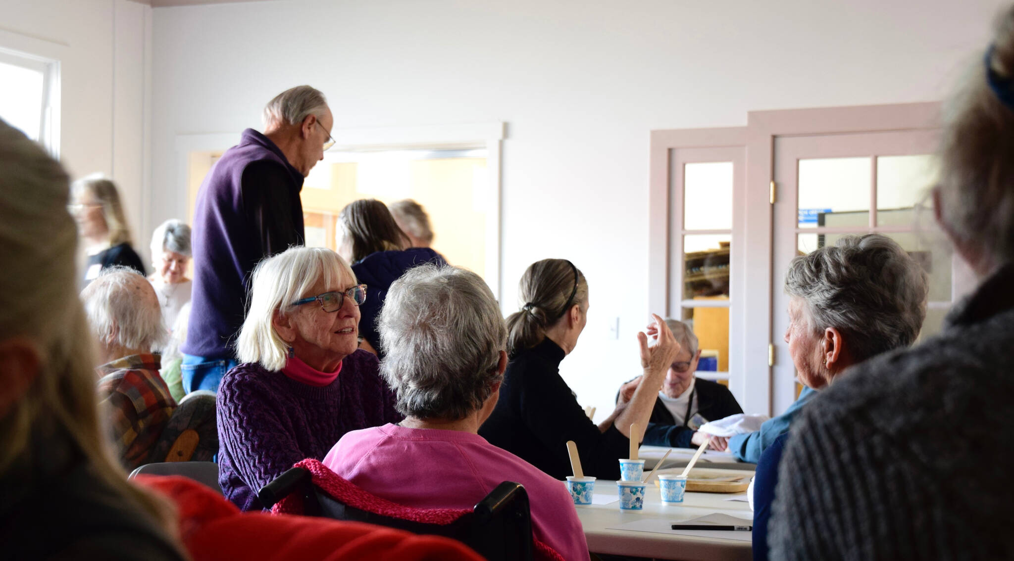 Members and volunteers chat after completing a hand-massage activity. (Tess Halpern Photo)