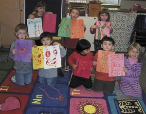 Preschoolers at Chautauqua kneel on an alphabet carpet purchased with PIE funds.