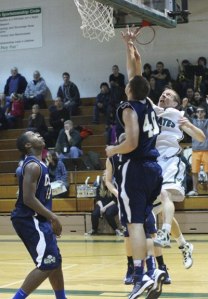 Pirate Ian Stewart shoots over the defense of Cedar Park's Daniel Christenson as time runs down in the fourth quarter of Friday's basketball game.