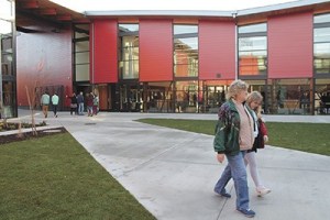 Visitors stroll through the courtyard of the brightly painted school during Sunday's open house.