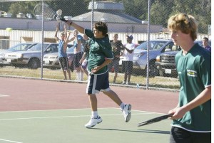 Ben Stemer returns a serve against Northwest Christian earlier this season as doubles partner Ethan Rumberg