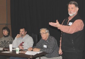 Craig Beles calls on a community member. Next to him