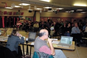 School board members Kathy Jones and John “Oz” Osborne listen to Islanders discuss the proposal.