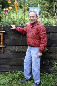Bill Champion near the colorful garden art at his home.