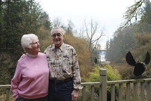 Elaine and Jim Scott stand on their deck