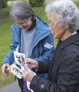 Glenda Pearson looks at photos of the farmhouse and the Mukai family that Mary Matsuda Gruenewald