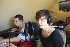 Peter Evans and Madeleine Wolczko work on a song in Evans’ music studio.