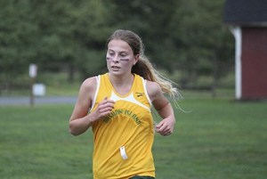 Freshman Jessica Merritt kicks down the final stretch of the Fort Steilacoom course on Tuesday