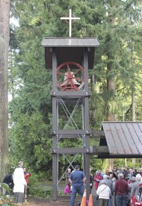 Islanders bless the bell and bell tower at a rededication  ceremony at the Church of the Holy Spirit on Sunday.  The bell was given to the church 50 years ago by the family of a young boy who drowned.