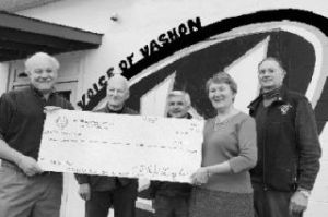 HELP GETTING PREPARED: Members of the Vashon Rotary gather with members of Voice of Vashon (VoV) to hand over a $10