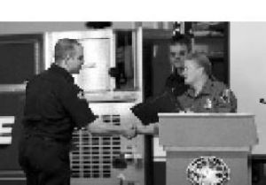 Erich Doughly receives his certificate from Capt. Candy McCullough