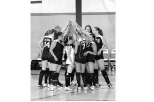 The Pirates huddle after winning the match over the Charles Wright Tarriers in four exciting games.
