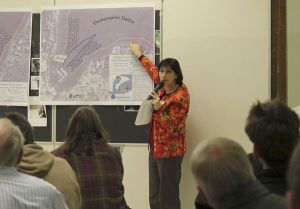 Lisa Randlette displays drawings of DNR’s plans for buoy locations in Quartermaster Harbor.