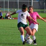 Brian Adams Photo                                VHS senior midfielder Mira Peterson (in pink) battles for the ball against her Charles Wright Academy opponent earlier this season. VHS beat Charles Wright last week to advance to state playoffs. See page 15 for the full story.