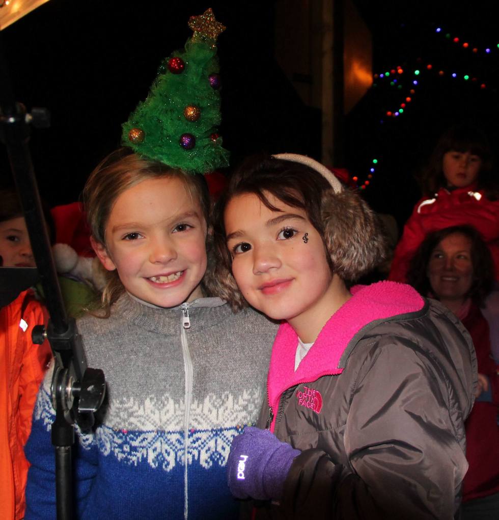 Two bundled-up girls pose for a photo during Winterfest festivities. (Susan Riemer/Staff Photo)