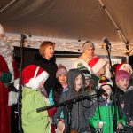 Children sing holiday songs with Santa and Mrs. Claus. (Susan Riemer/Staff Photo)