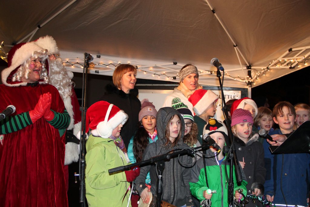 Children sing holiday songs with Santa and Mrs. Claus. (Susan Riemer/Staff Photo)
