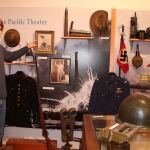 Kjell Urban stands with his collection of World War II memorabilia at the Vashon Maury Island Heritage Museum. His collection is currently on display as the museum&rsquo;s newest exhibit, &ldquo;Vashon and World War II: A Personal Collection.&rdquo; (Juli Goetz Morser/Staff Photo)