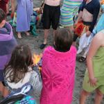 Children gather around one of two fires built to thaw out participants after the plunge. (Anneli Fogt/Staff Photo)
