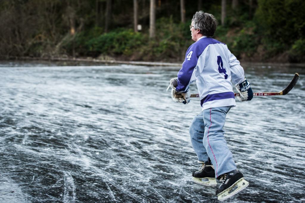 A man glides across the ice playing hockey during a cold day earlier this winter. (Cassie Bergman Photo)
