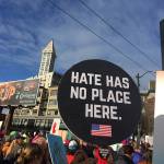 Islander Jenna Riggs&rsquo; &ldquo;Hate Has No Place Here&rdquo; sign rises next to Smith Tower. (Kathryn True Photo)