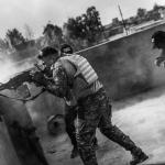 A member of Iraq&rsquo;s Nineveh Province&rsquo;s elite SWAT team fires at a cache of ISIS explosives near Mosul. (Victor J. Blue for The New Yorker Photo)