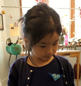 Customer wearing a paper heart made by Alice Larson. (Courtesy photo)